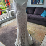 Beaded mermaid wedding dress with a deep plunging neckline and thin straps, handcrafted bespoke bridal gown