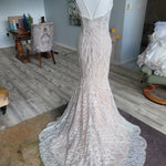 Bespoke beaded mermaid wedding dress with geometric lace and thin straps, handcrafted bridal gown