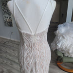 Bespoke beaded mermaid wedding dress with a plunging low back and thin straps, handcrafted bridal gown