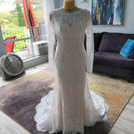 Long sleeve mermaid lace wedding dress with boat neck and handcrafted floral patterns, bespoke bridal gown