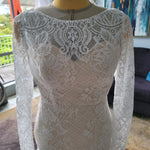 Bespoke long sleeve lace mermaid wedding dress with a boat neck and floral patterns, handcrafted bridal gown