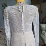 Handcrafted long sleeve lace mermaid wedding dress with boat neck and sheer button back, bespoke bridal gown