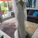 Boho mermaid lace wedding gown with deep plunging neckline and fringed bell sleeves, bespoke handcrafted bridal gown