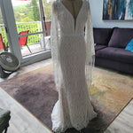 Boho mermaid lace wedding dress with deep plunging neckline and fringe bell sleeves, handcrafted bridal gown