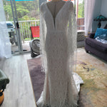 Boho mermaid geometric lace wedding dress with deep plunging neckline and fringe bell sleeves, bespoke bridal gown