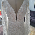 Boho lace mermaid wedding dress with deep plunging neckline and fringed bell sleeves, handcrafted bridal gown