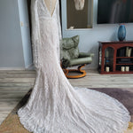 Boho mermaid lace wedding dress with fringe bell sleeves and deep plunging back, bespoke handcrafted bridal gown