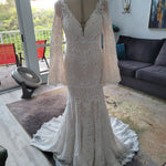 Mermaid crochet lace wedding dress with a deep V-neck and boho bell sleeves, handcrafted bridal gown