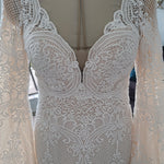 Bespoke crochet lace mermaid wedding dress with deep V-neck and bell sleeves, handcrafted boho bridal gown