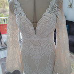 Mermaid crochet lace wedding dress with a deep V-neck and boho bell sleeves, handcrafted bridal gown