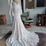 Bespoke mermaid crochet lace wedding dress with bell sleeves and a buttoned sheer back, handcrafted wedding gown.