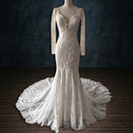 Mermaid beaded lace wedding dress with long sleeves and deep plunging V-neck, a handcrafted boho bridal gown