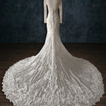 Mermaid beaded lace wedding dress with long sleeves and a dramatic train, bespoke boho bridal gown