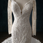 Bespoke beaded boho lace mermaid wedding dress with long sleeves and plunging V-neck, handcrafted bridal gown